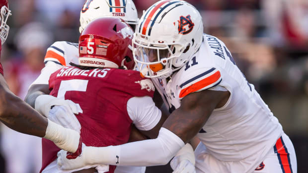 Razorbacks running back Raheim "Rocket" Sanders is tackled by Auburn's Elijah McAllister